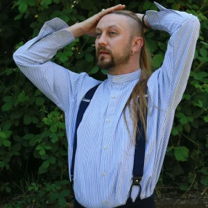 Collarless shirt in heavy cotton ticking, blue and white stripe, button through to hem, front pocket